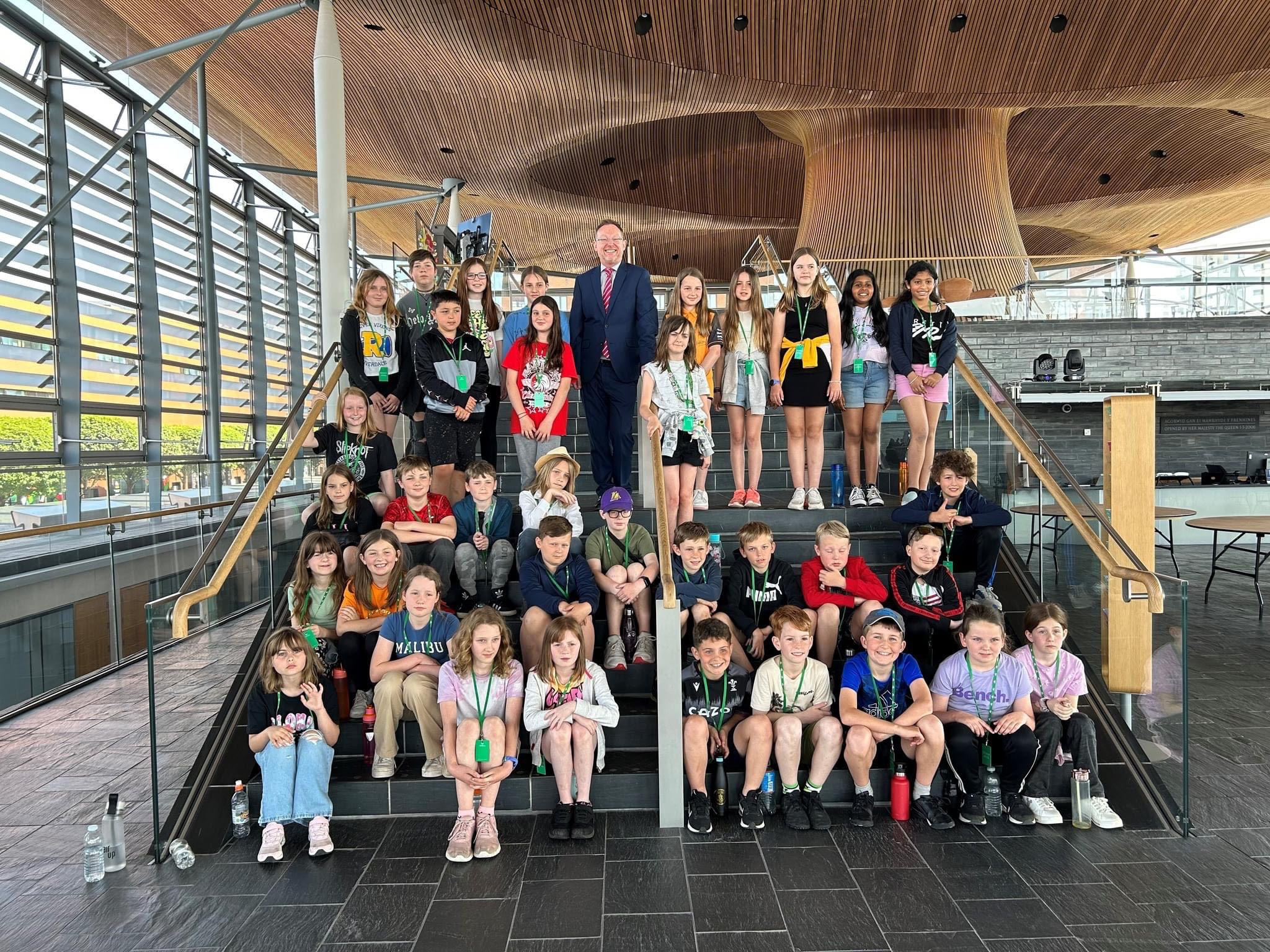 Russell George MS welcomes a group to the Senedd.
